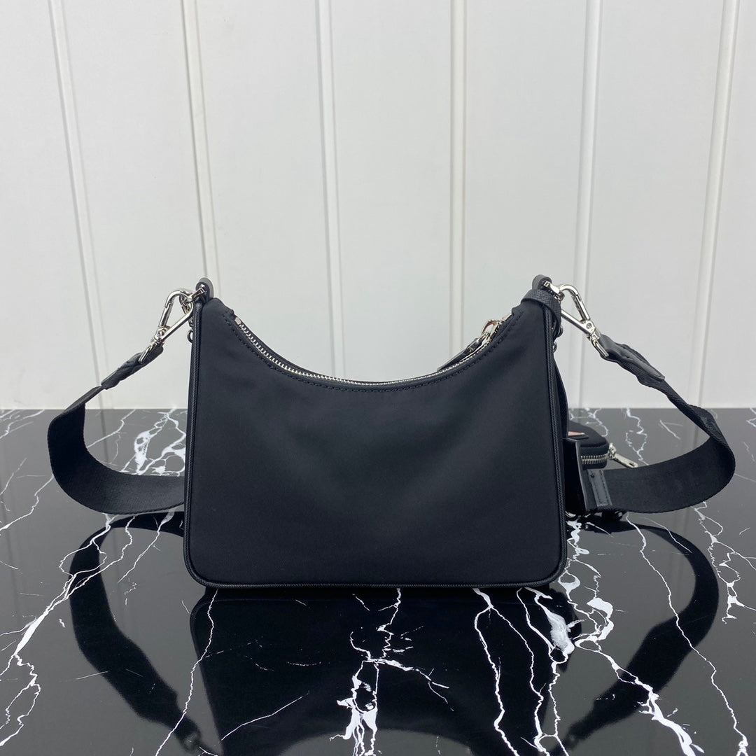 PRADA HOBO 22 BAG IN BLACK RE-NYLON WITH RED LOGO