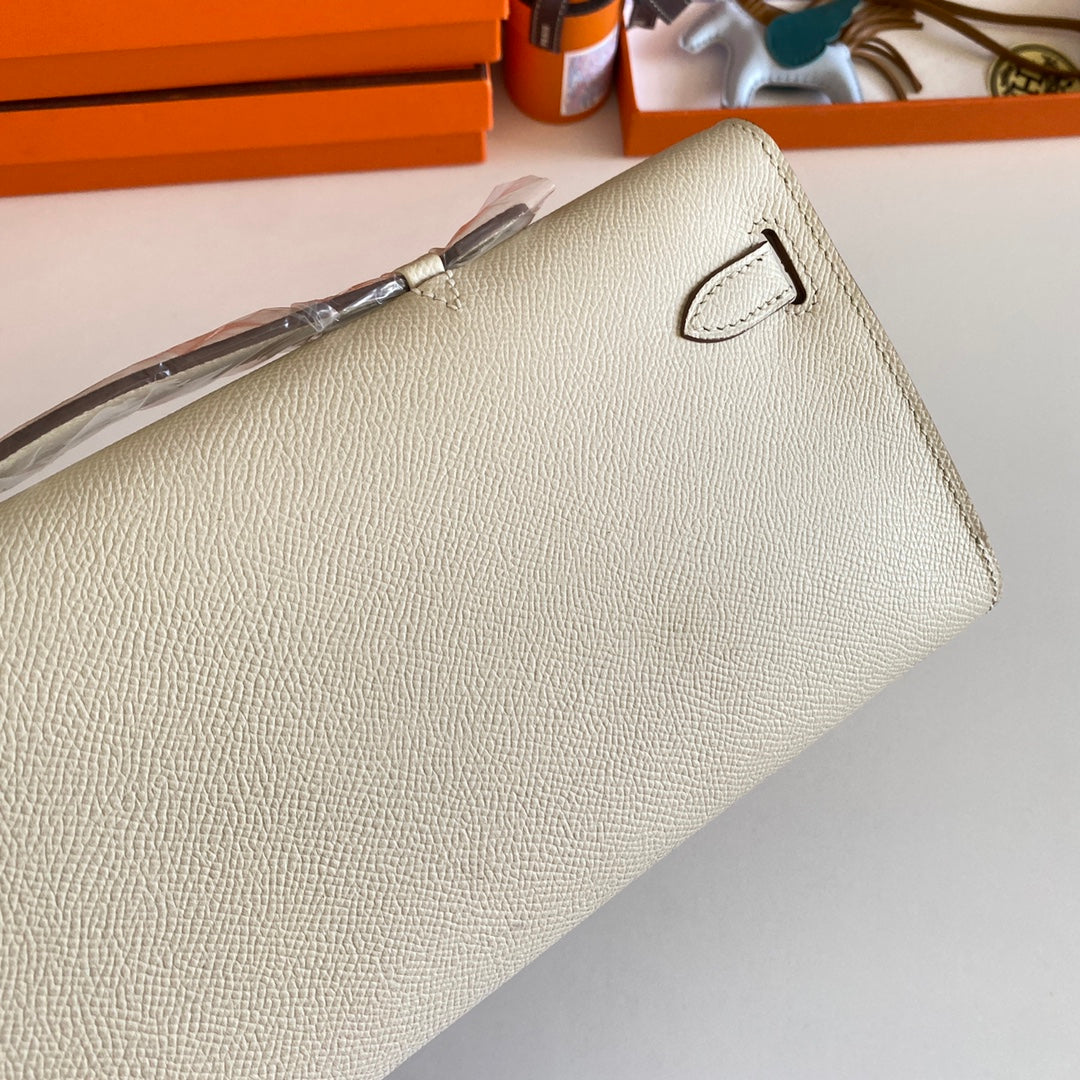 HERMES KELLY CUT 31 IN BEIGE CREAM CALFSKIN WITH SILVER HARDWARE