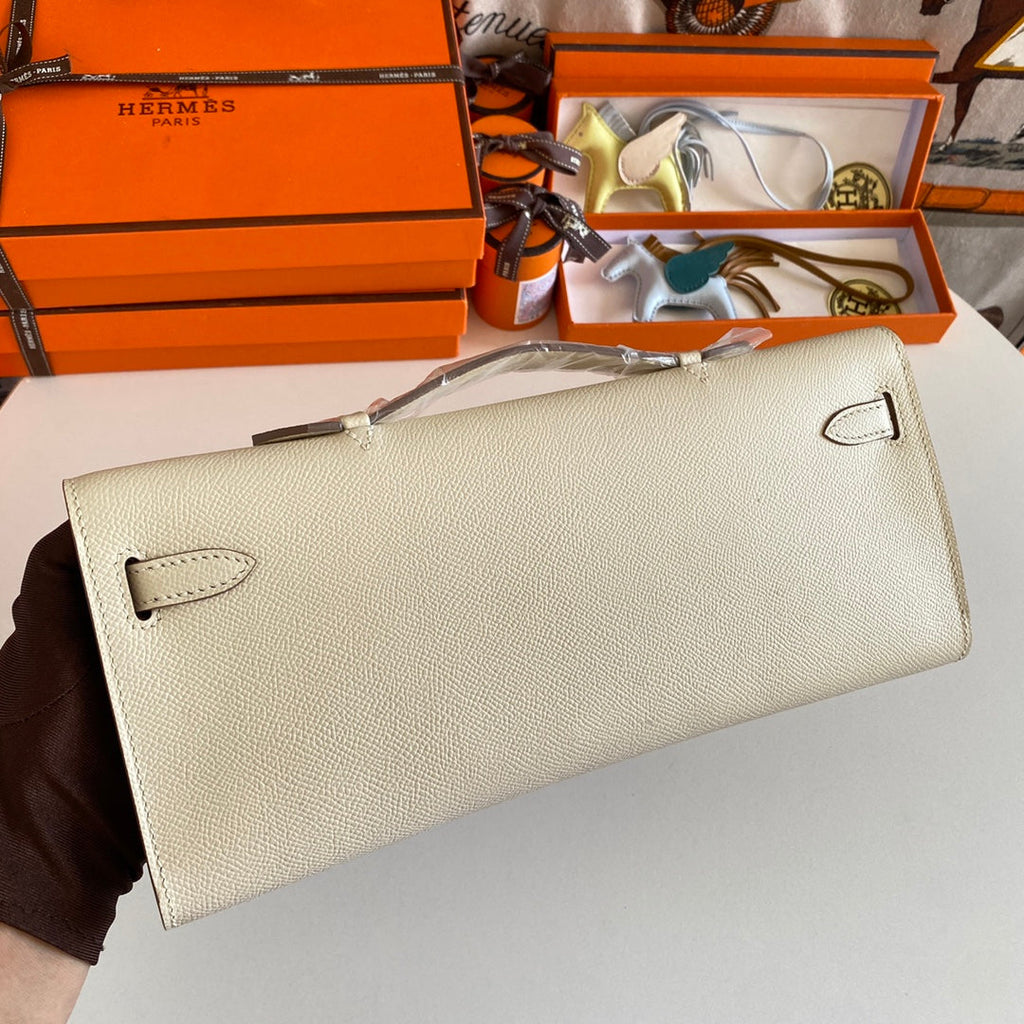 HERMES KELLY CUT 31 IN BEIGE CREAM CALFSKIN WITH SILVER HARDWARE