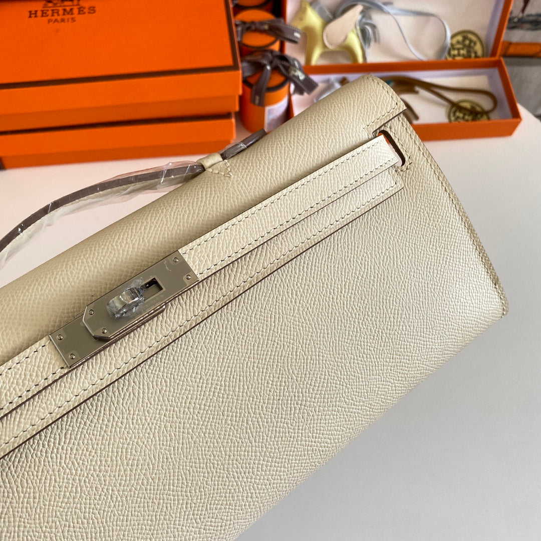 HERMES KELLY CUT 31 IN BEIGE CREAM CALFSKIN WITH SILVER HARDWARE