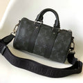 LOUIS VUITTON KEEPALL BANDOULIÈRE 25 IN BLACK MONOGRAM HERITAGE CANVAS