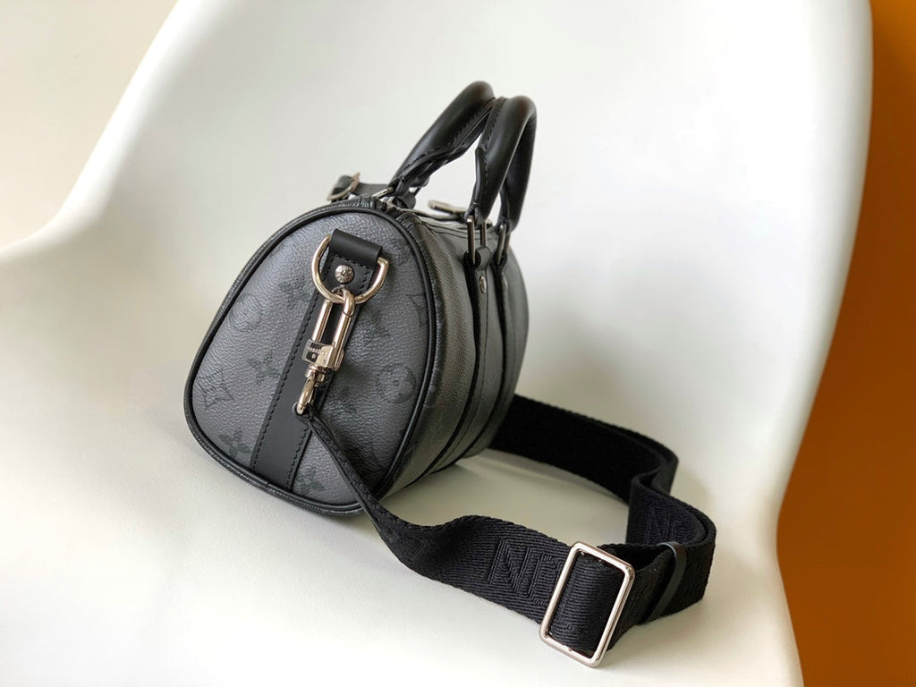 LOUIS VUITTON KEEPALL BANDOULIÈRE 25 IN BLACK MONOGRAM HERITAGE CANVAS