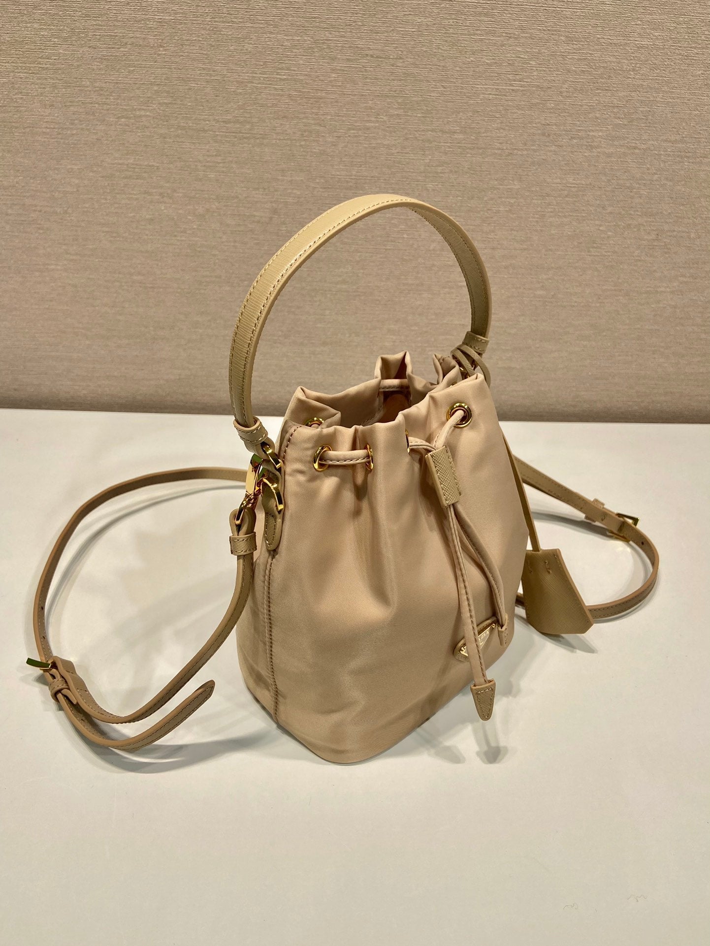 PRADA BUCKET BAG 19 IN BEIGE RE-NYLON AND SAFFIANO LEATHER HANDLE