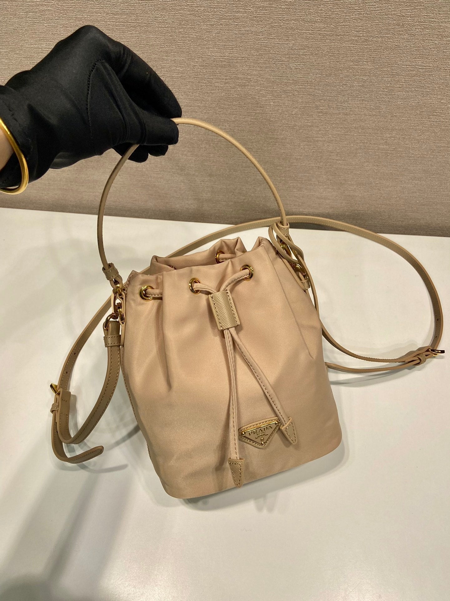 PRADA BUCKET BAG 19 IN BEIGE RE-NYLON AND SAFFIANO LEATHER HANDLE
