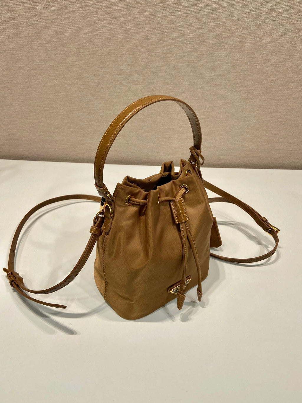 PRADA BUCKET BAG 19 IN RUSSET BROWN RE-NYLON AND CALFSKIN HANDLE