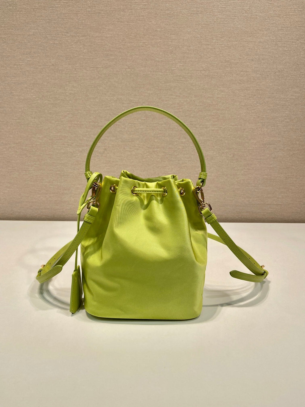 PRADA BUCKET BAG 19 IN APPLE GREEN RE-NYLON AND SAFFIANO LEATHER HANDLE