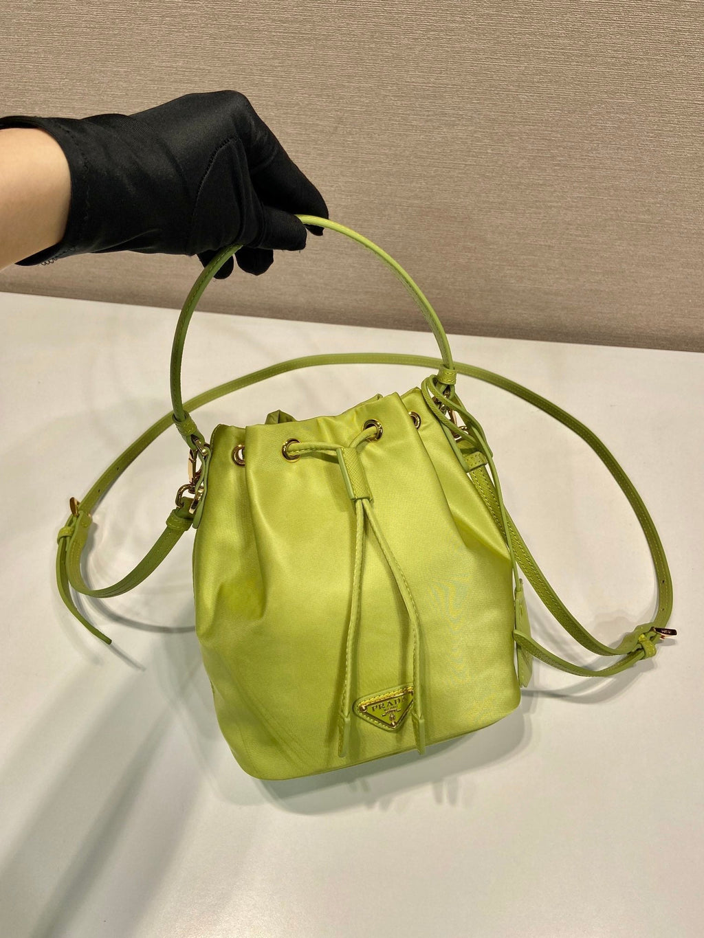 PRADA BUCKET BAG 19 IN APPLE GREEN RE-NYLON AND SAFFIANO LEATHER HANDLE