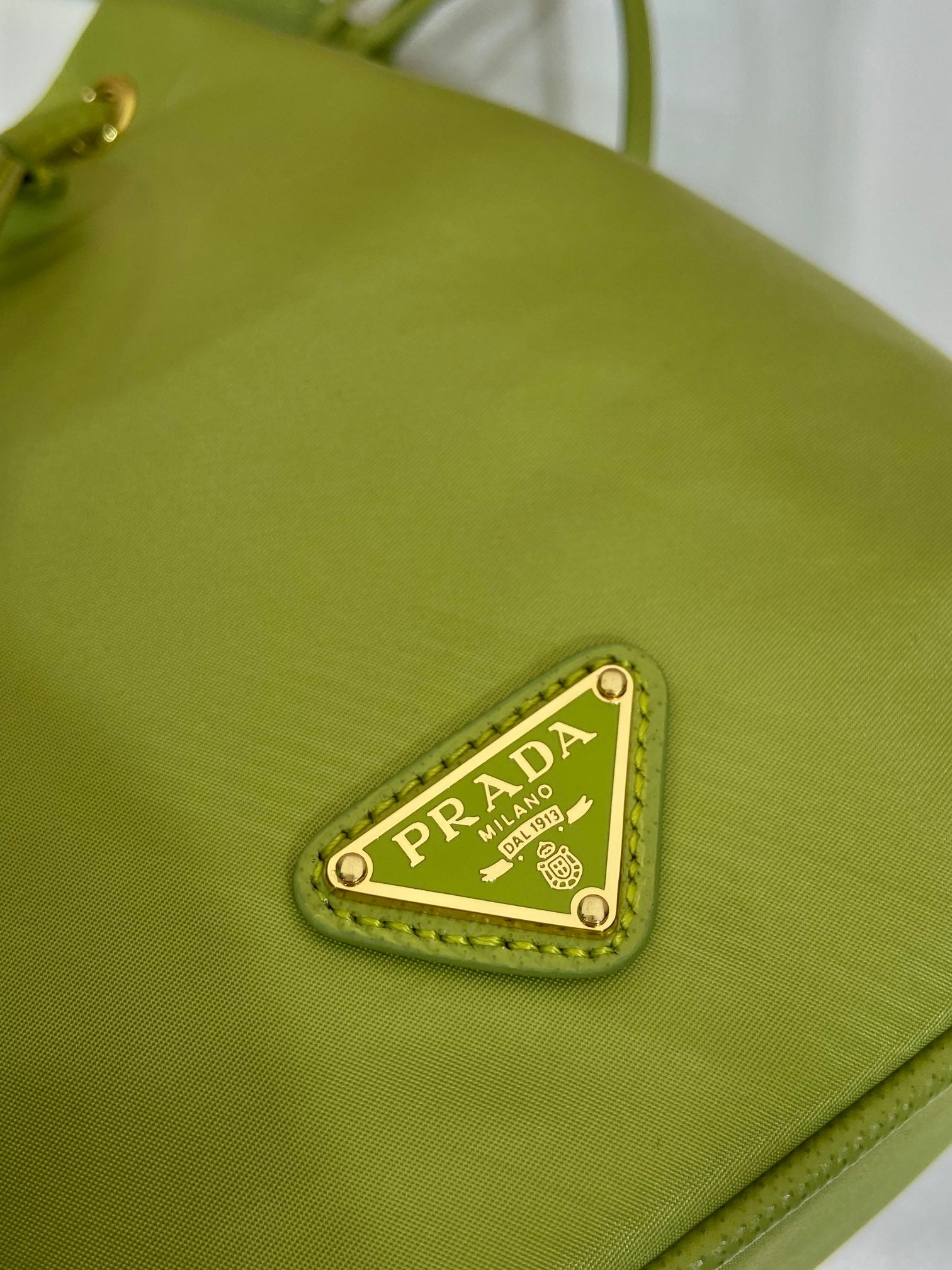 PRADA BUCKET BAG 19 IN APPLE GREEN RE-NYLON AND SAFFIANO LEATHER HANDLE