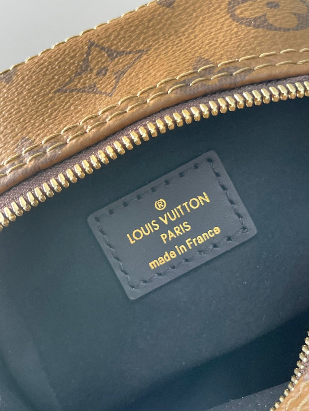 LOUIS VUITTON DICE 9 IN BROWN MONOGRAM AND MONOGRAM REVERSE CANVAS GOLD HARDWARE