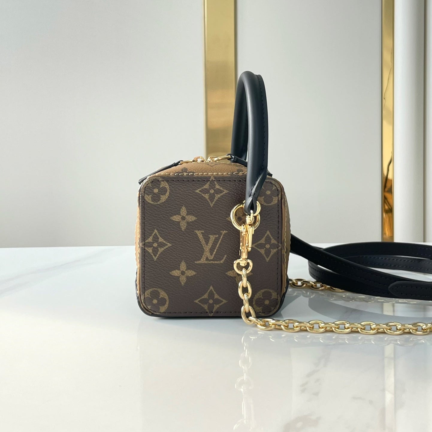 LOUIS VUITTON DICE 9 IN BROWN MONOGRAM AND MONOGRAM REVERSE CANVAS GOLD HARDWARE