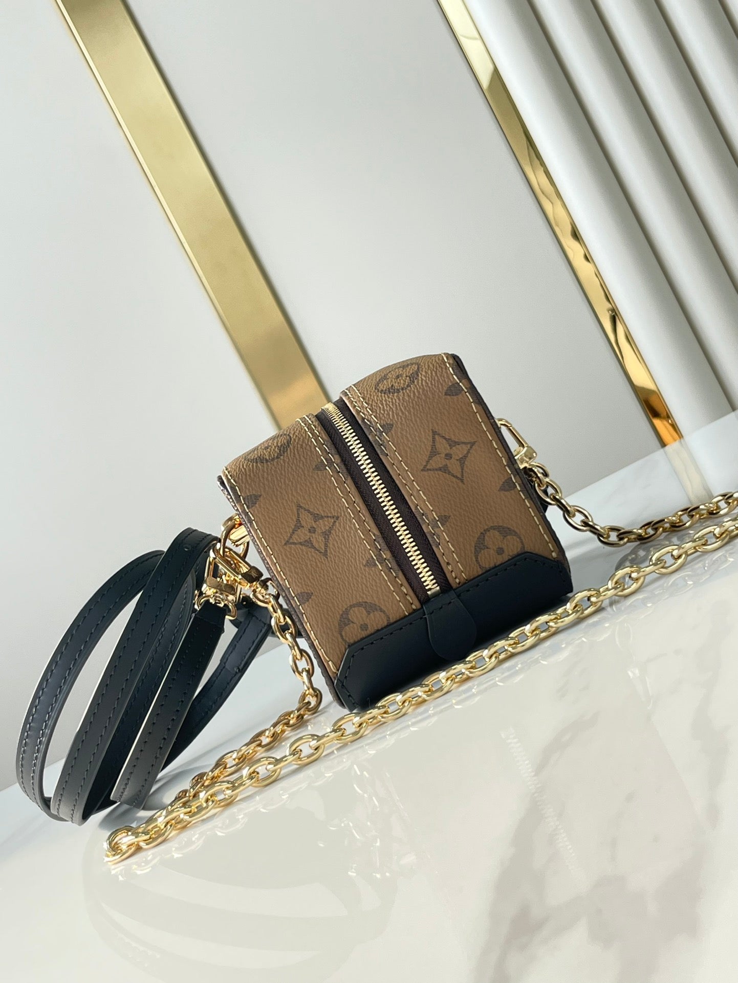 LOUIS VUITTON DICE 9 IN BROWN MONOGRAM AND MONOGRAM REVERSE CANVAS GOLD HARDWARE