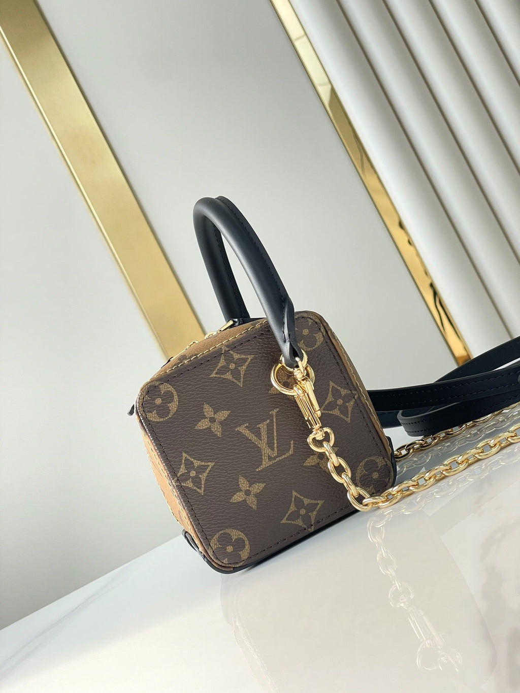 LOUIS VUITTON DICE 9 IN BROWN MONOGRAM AND MONOGRAM REVERSE CANVAS GOLD HARDWARE
