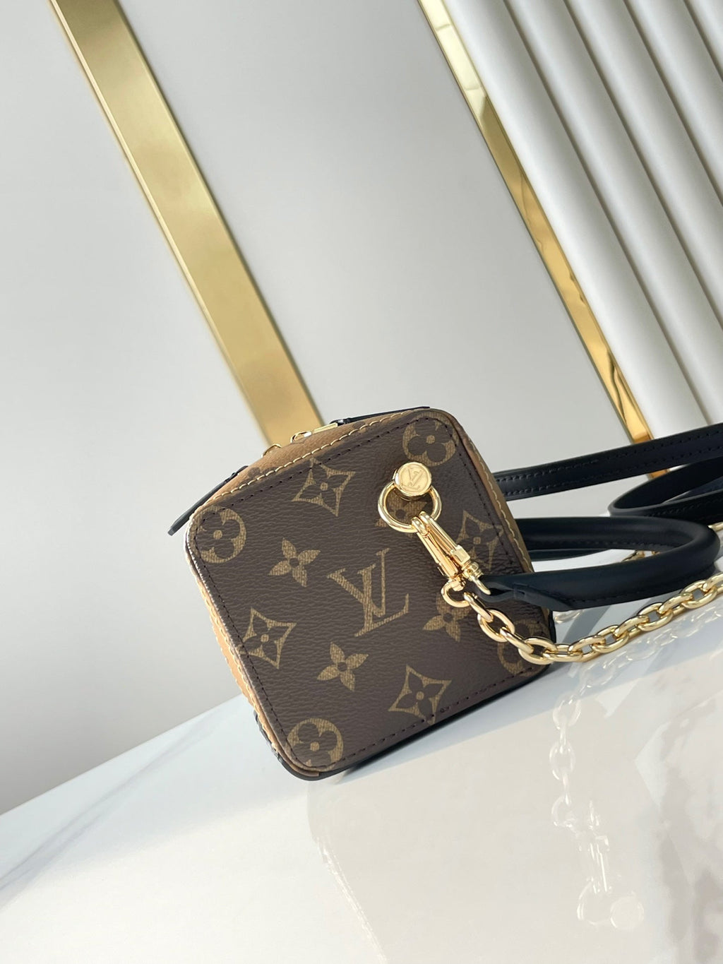 LOUIS VUITTON DICE 9 IN BROWN MONOGRAM AND MONOGRAM REVERSE CANVAS GOLD HARDWARE