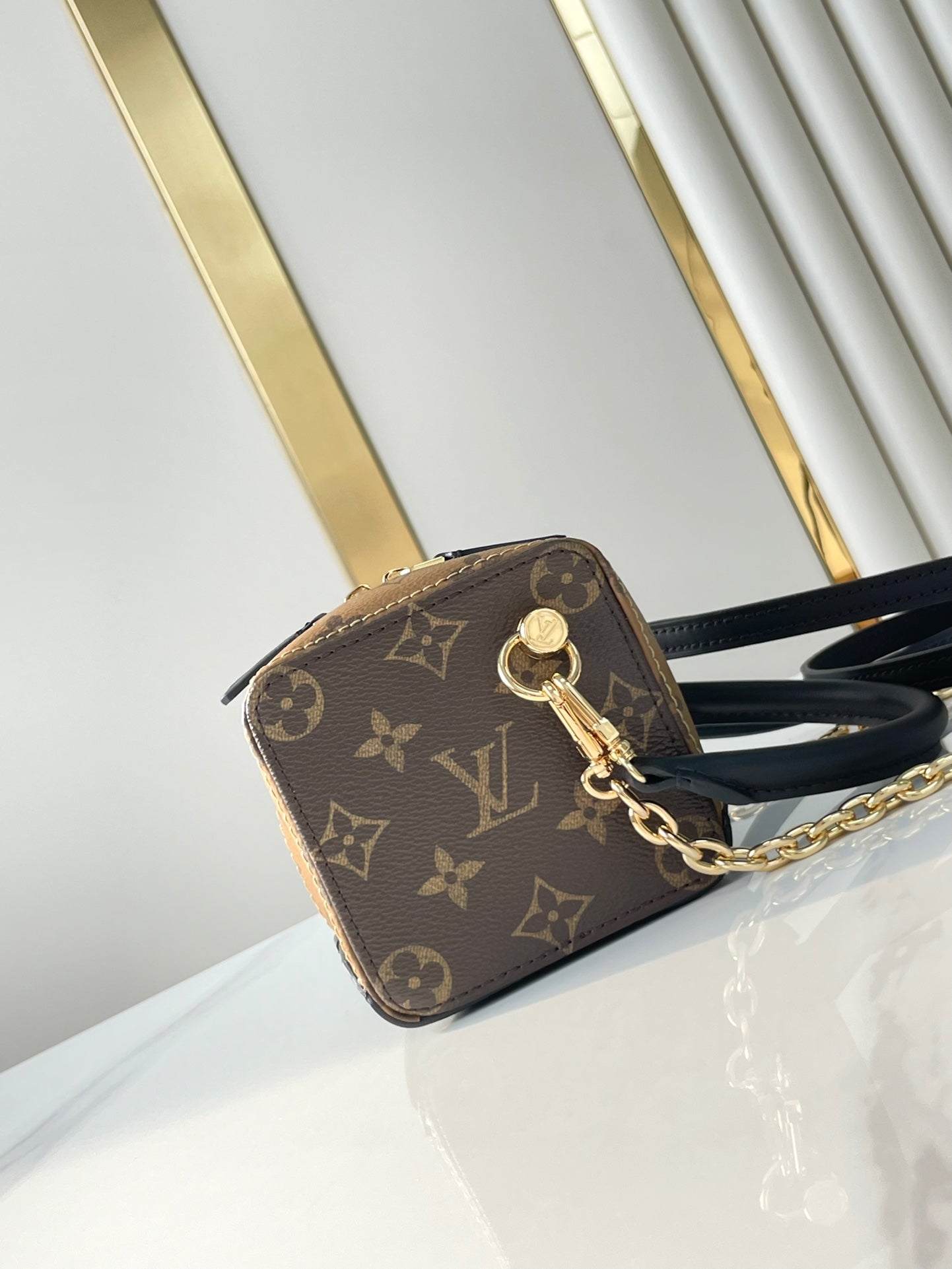 LOUIS VUITTON DICE 9 IN BROWN MONOGRAM AND MONOGRAM REVERSE CANVAS GOLD HARDWARE