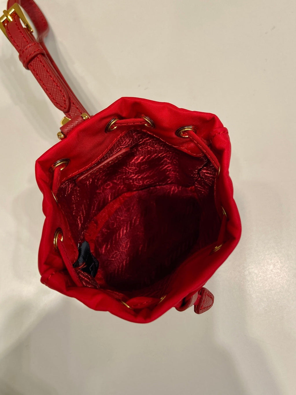 PRADA MINI BUCKET BAG 10 IN RED RE-NYLON AND SAFFIANO LEATHER STRAP