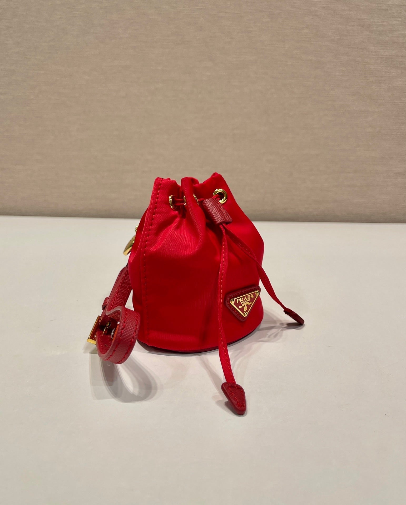 PRADA MINI BUCKET BAG 10 IN RED RE-NYLON AND SAFFIANO LEATHER STRAP