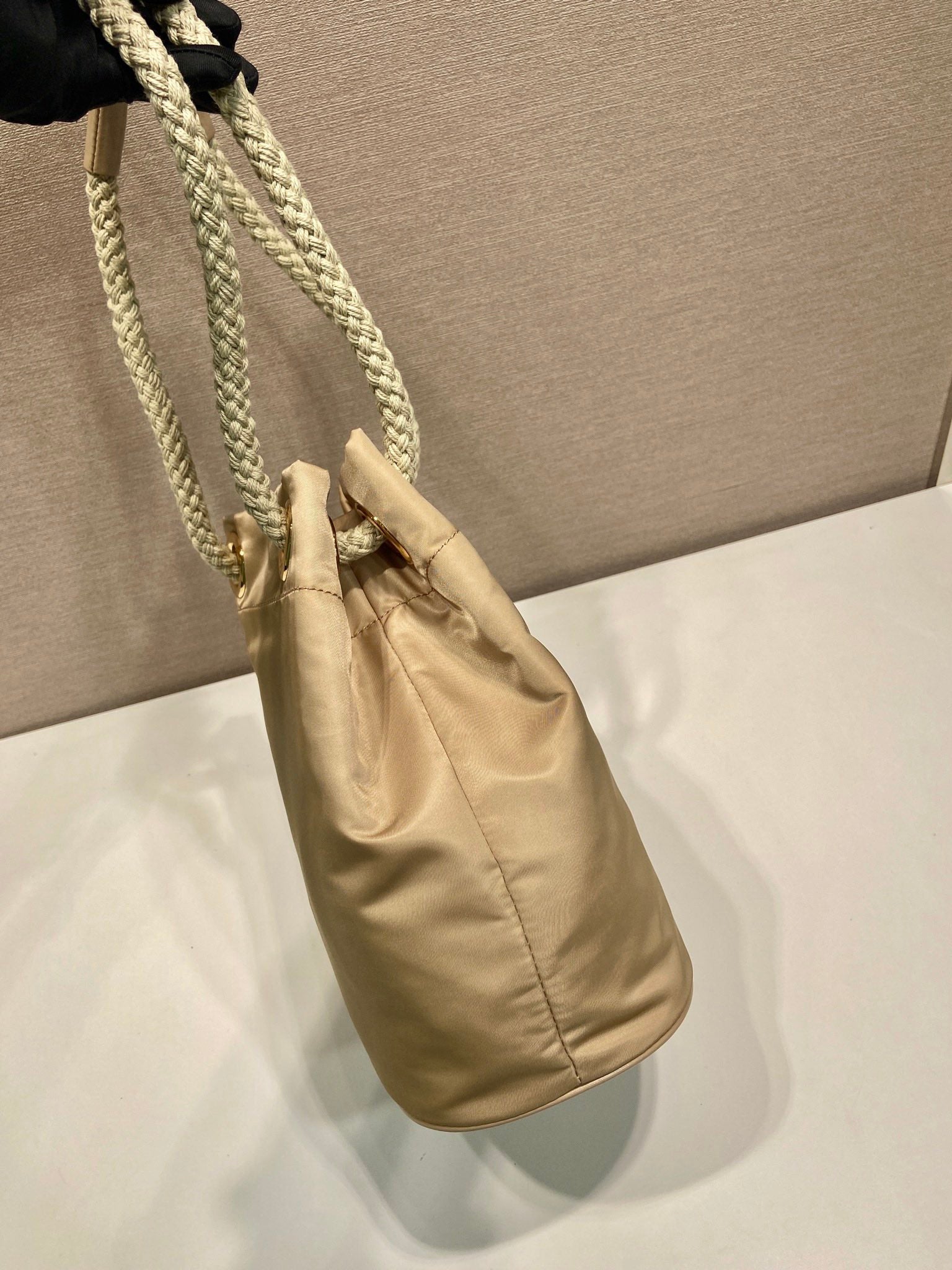 PRADA BUCKET BAG 28 IN BEIGE RE-NYLON GOLD LOGO