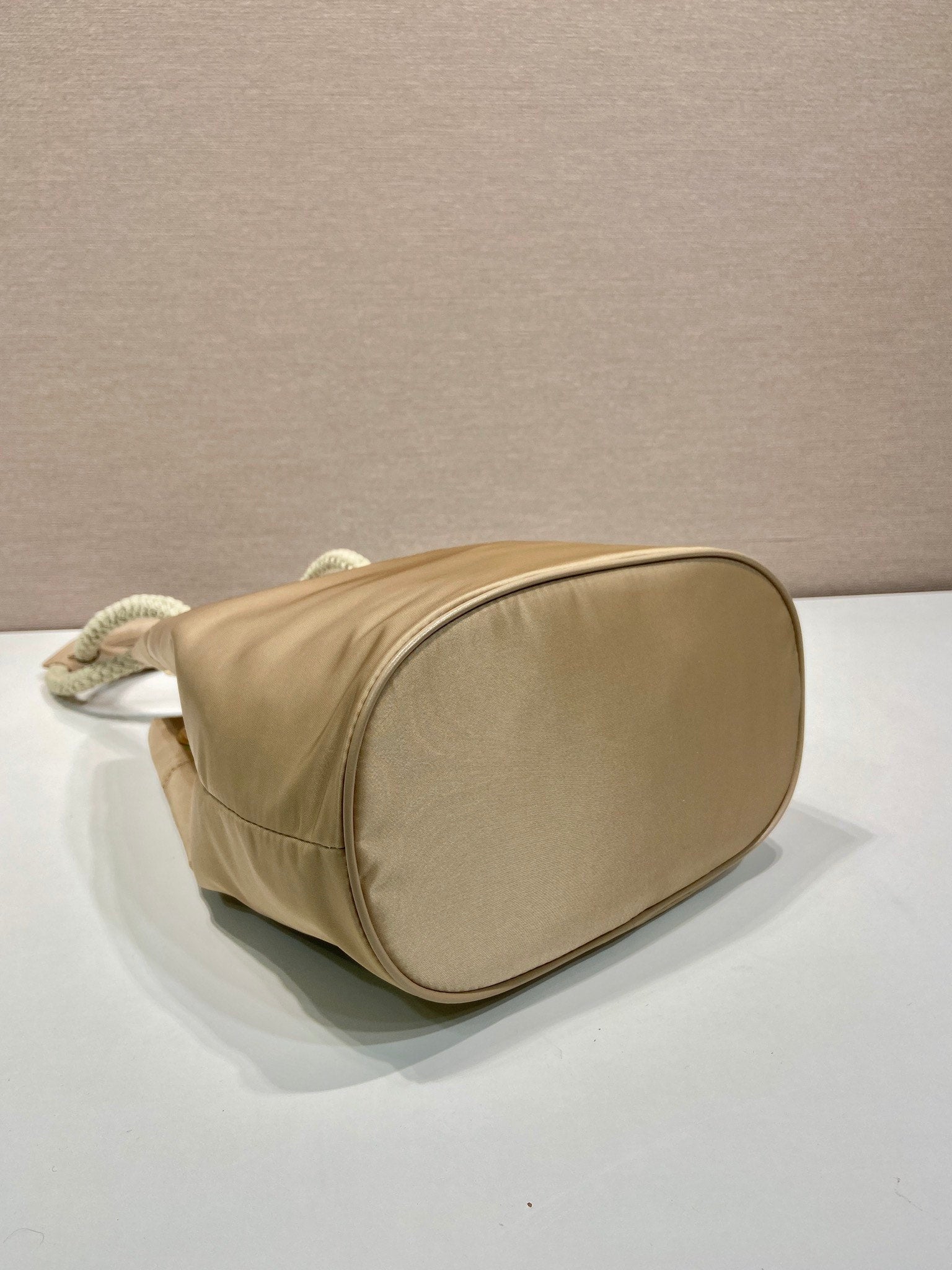 PRADA BUCKET BAG 28 IN BEIGE RE-NYLON GOLD LOGO