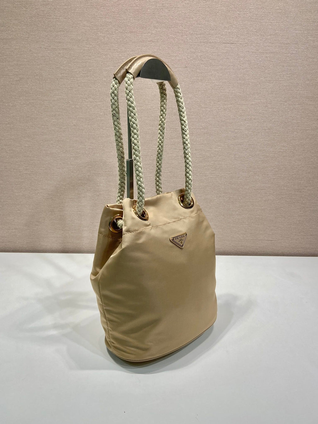 PRADA BUCKET BAG 28 IN BEIGE RE-NYLON GOLD LOGO