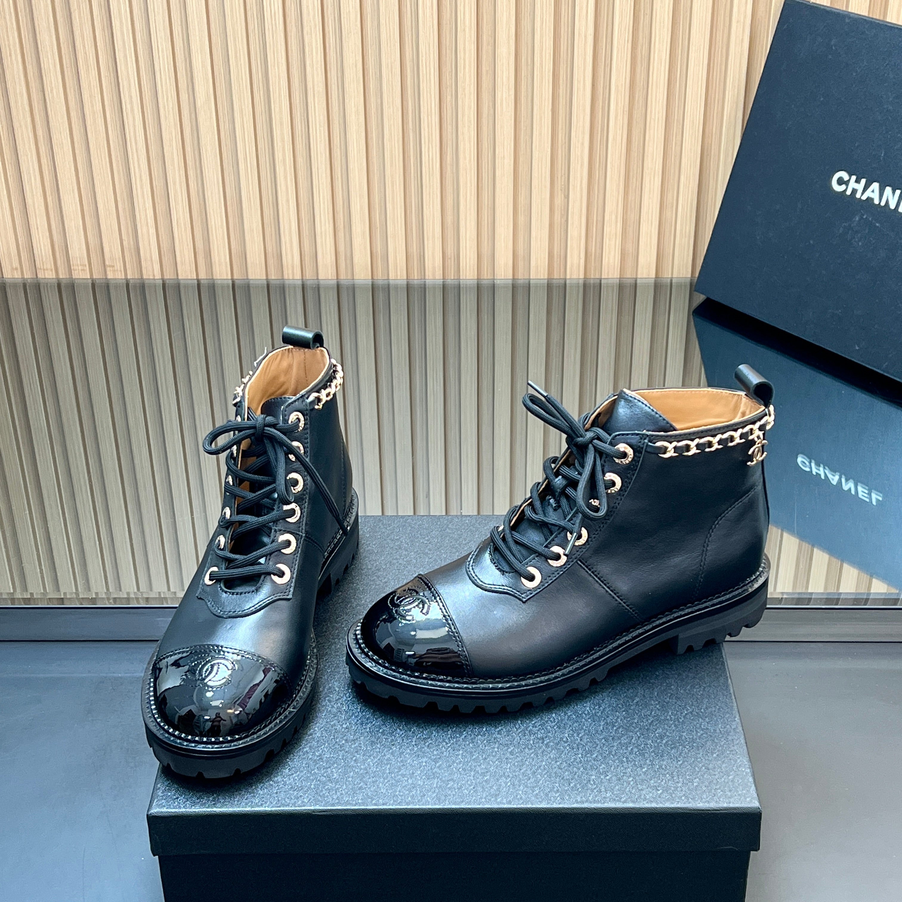CHANEL 25S MARTIN LACE-UP BOOTS WITH CHAIN DETAIL IN BLACK CALFSKIN