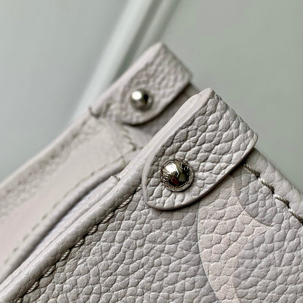 LOUIS VUITTON ONTHEGO EAST WEST BAG 25 IN BICOLOR MONOGRAM EMPREINTE LEATHER
