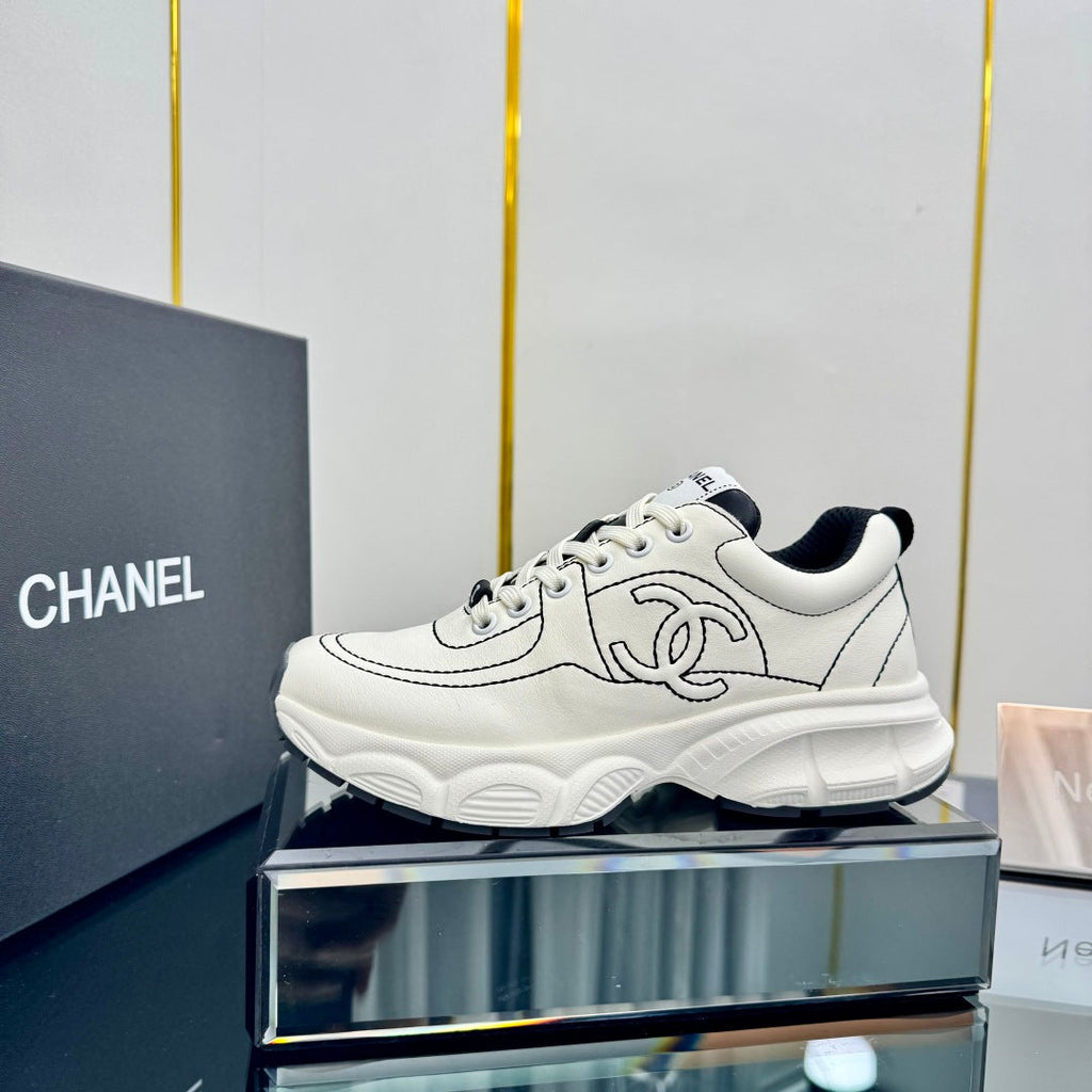 CHANEL TRAINERS SNEAKER IN WHITE CALFSKIN WITH BLACK EMBROIDERED