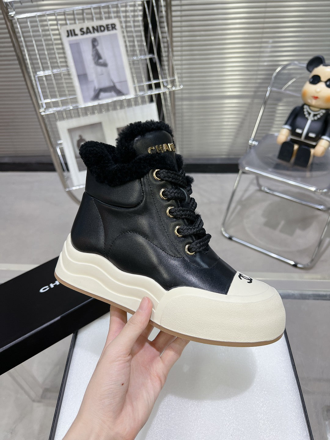 CHANEL MARTIN BOOTS IN BLACK CALFSKIN AND LAMB FUR LINING