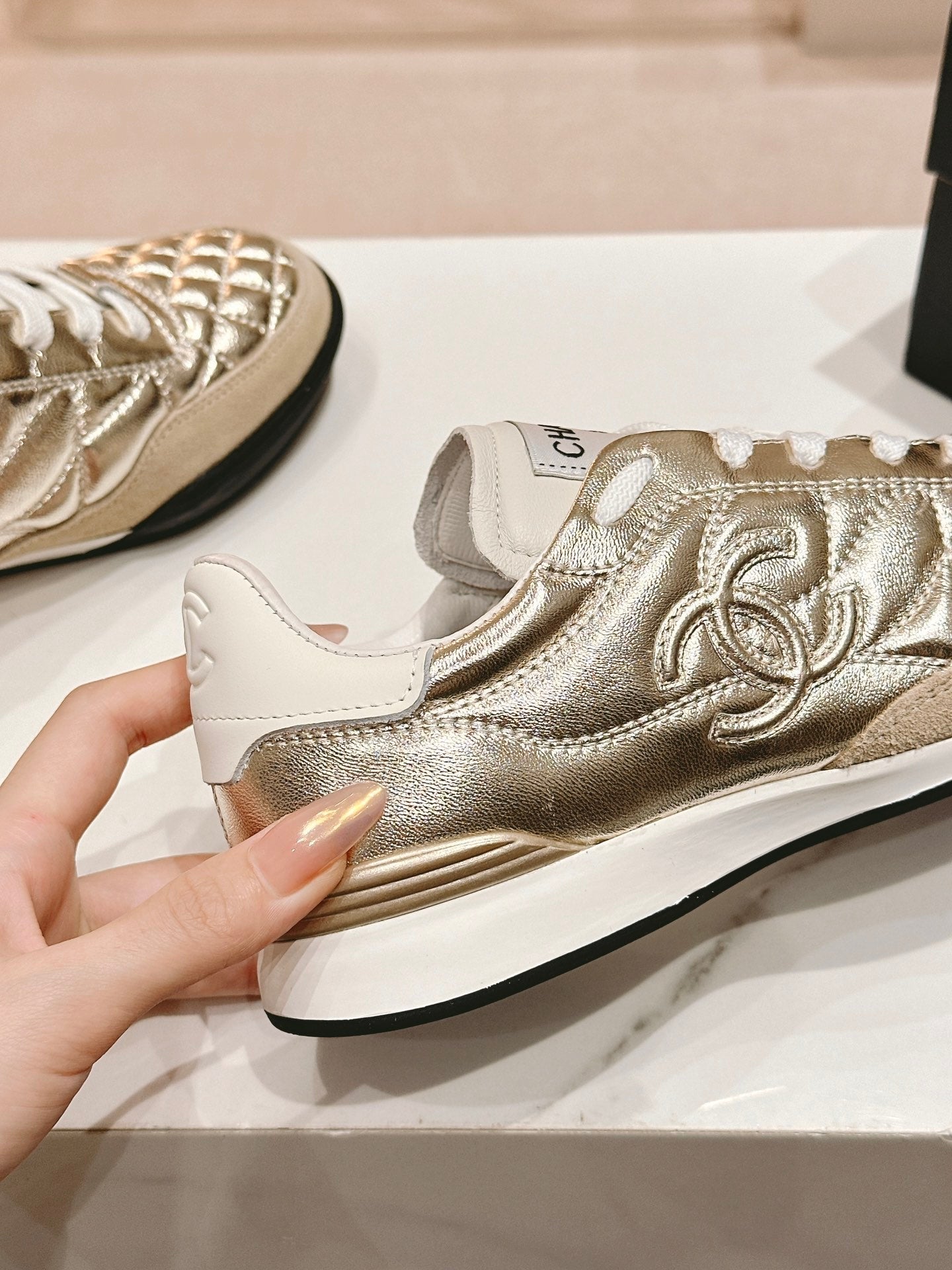 CHANEL SNEAKERS IN GLOSSY GOLDEN LAMBSKIN