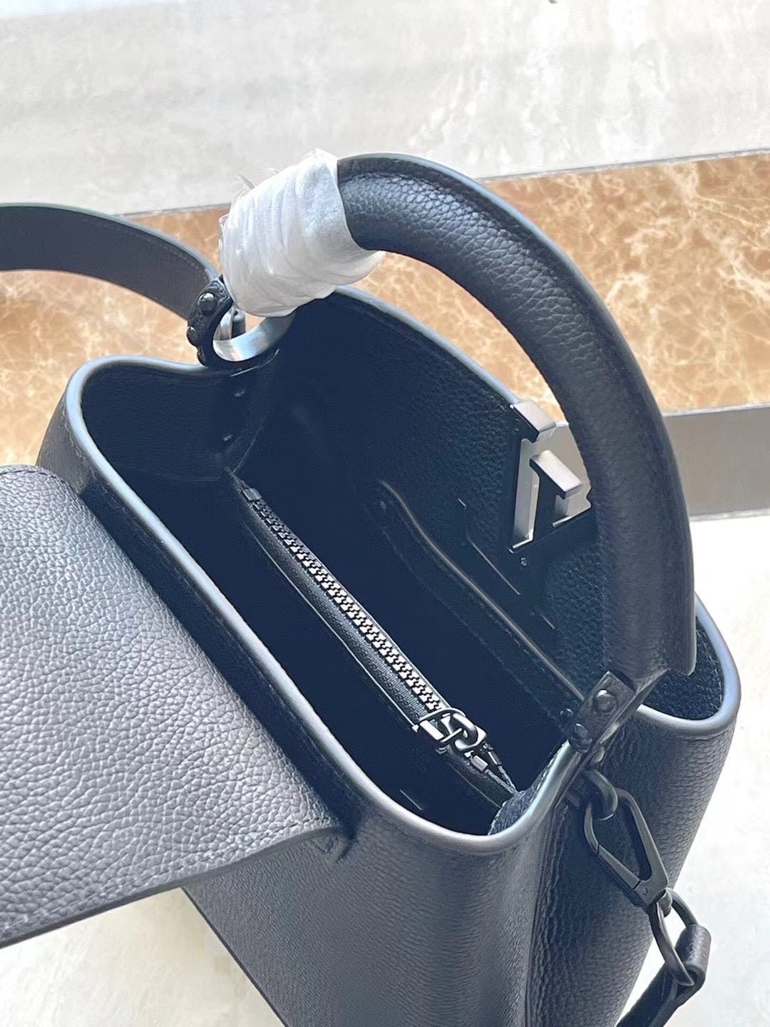 LOUIS VUITTON CAPUCINES EAST-WEST MINI 21 IN BLACK TAURILLON