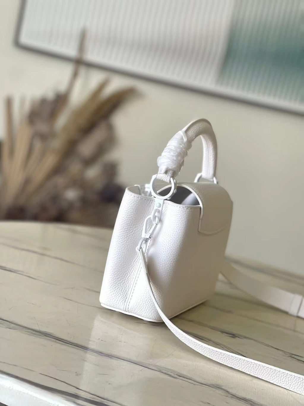 LOUIS VUITTON CAPUCINES EAST-WEST MINI 21 IN WHITE TAURILLON