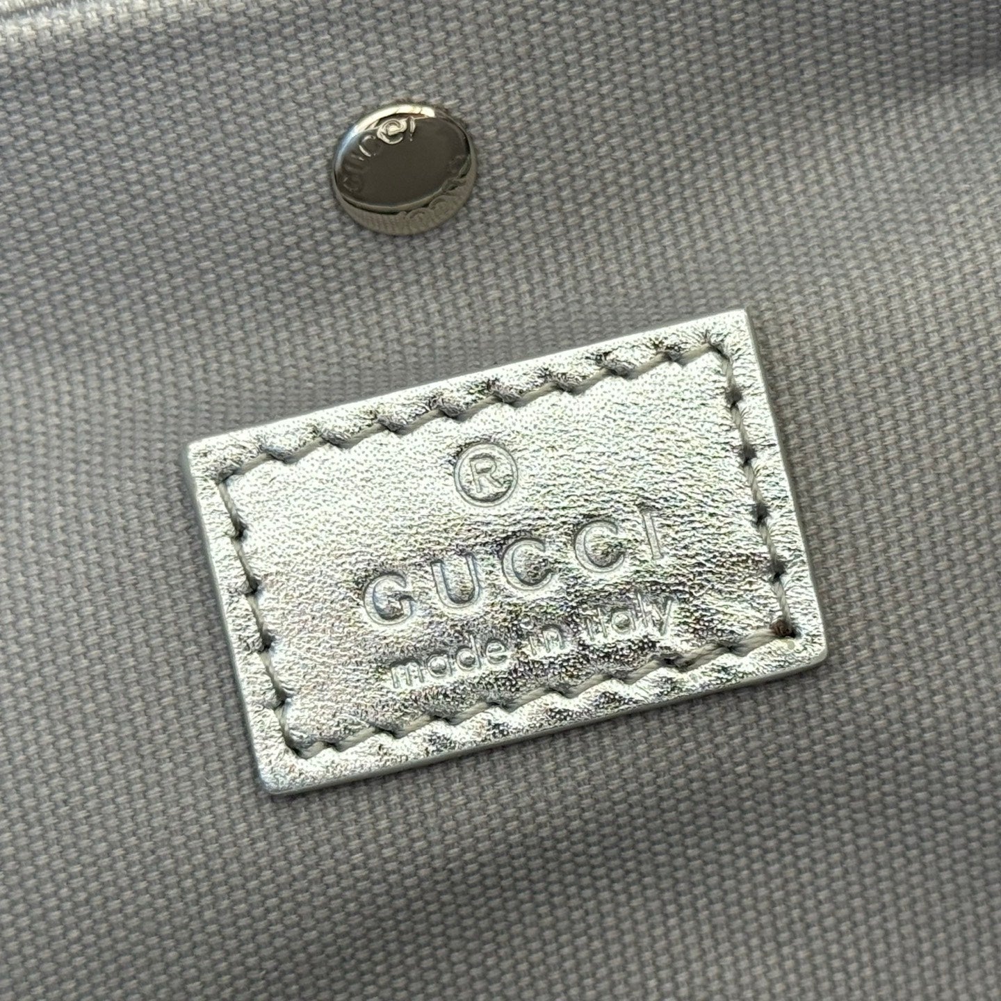 GUCCI 26S  EMBLEM BUCKET BAG 19 IN BEIGE AND SILVER CANVAS