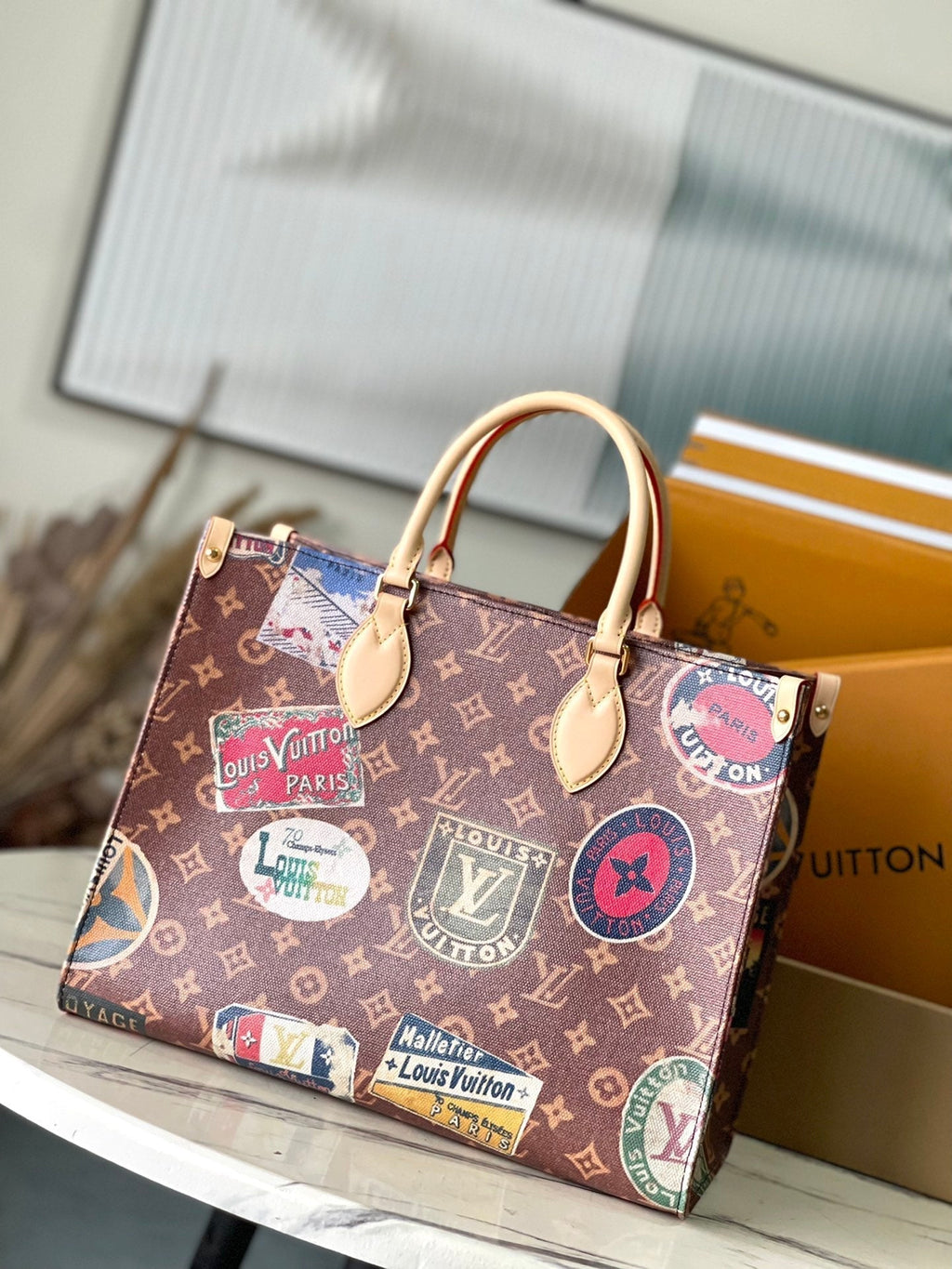 LOUIS VUITTON ONTHEGO VOYAGE 35 IN BROWN MONOGRAM CANVAS WITH VINTAGE HOTEL LABELS
