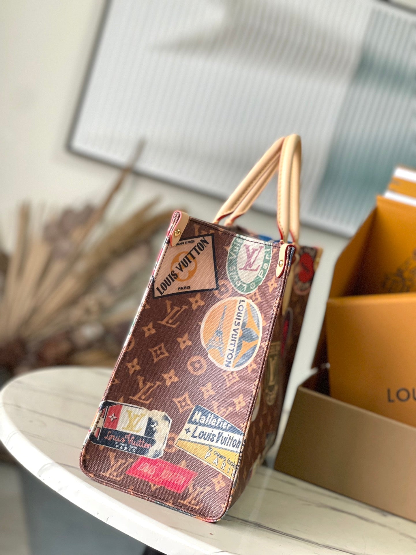 LOUIS VUITTON ONTHEGO VOYAGE 35 IN BROWN MONOGRAM CANVAS WITH VINTAGE HOTEL LABELS