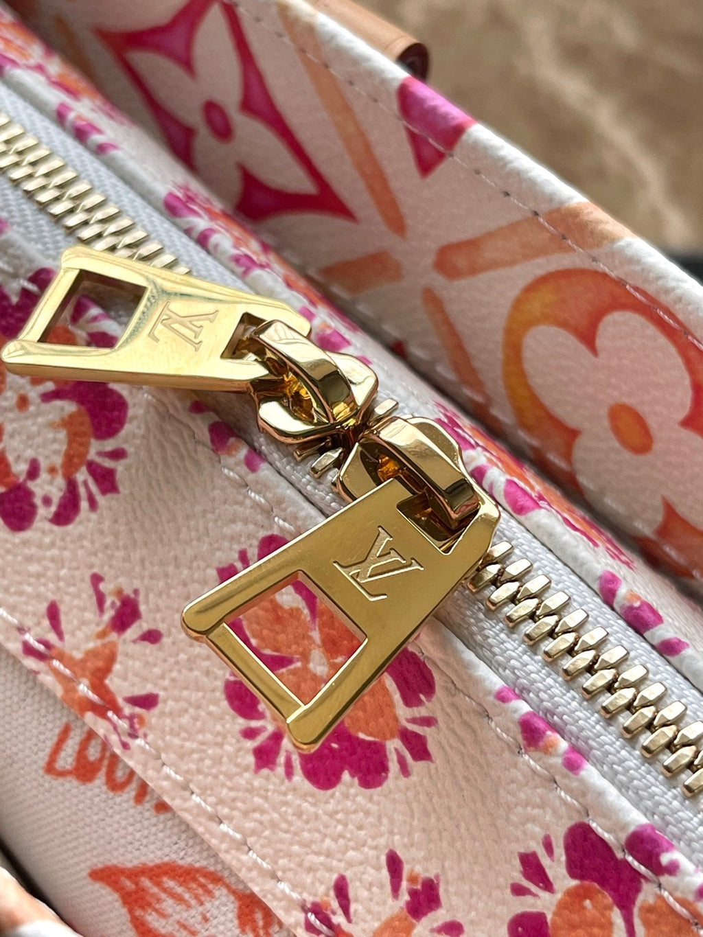 LOUIS VUITTON ONTHEGO EAST WEST 25 IN CORAL MONOGRAM TILES CANVAS