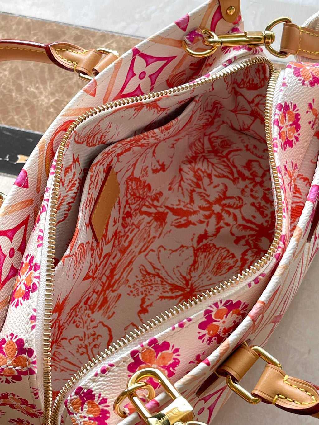 LOUIS VUITTON ONTHEGO EAST WEST 25 IN CORAL MONOGRAM TILES CANVAS