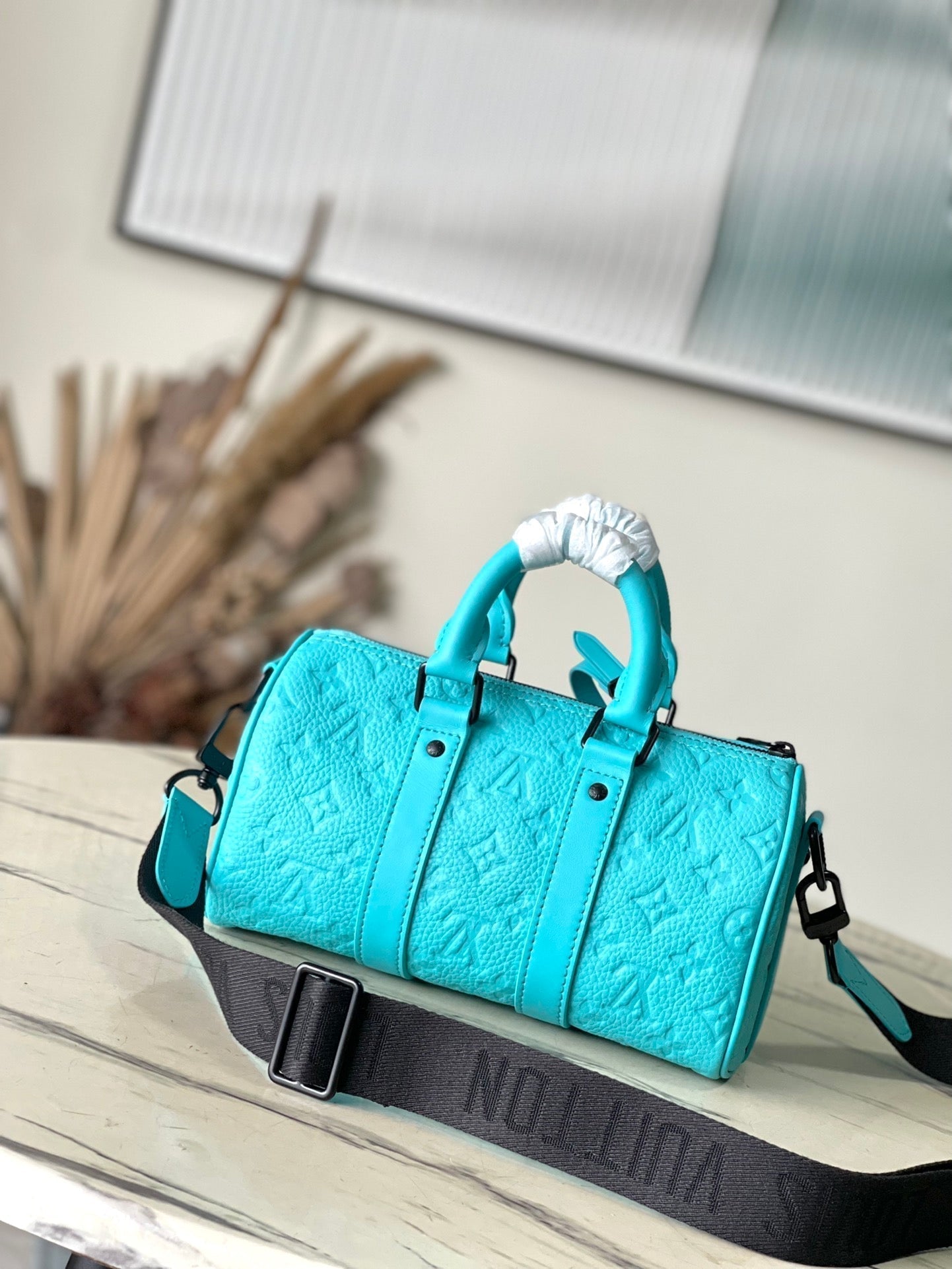 LOUIS VUITTON KEEPALL BANDOULIÈRE 25 IN TURQUOISE BLUE MONOGRAM EMBOSSED CALFSKIN