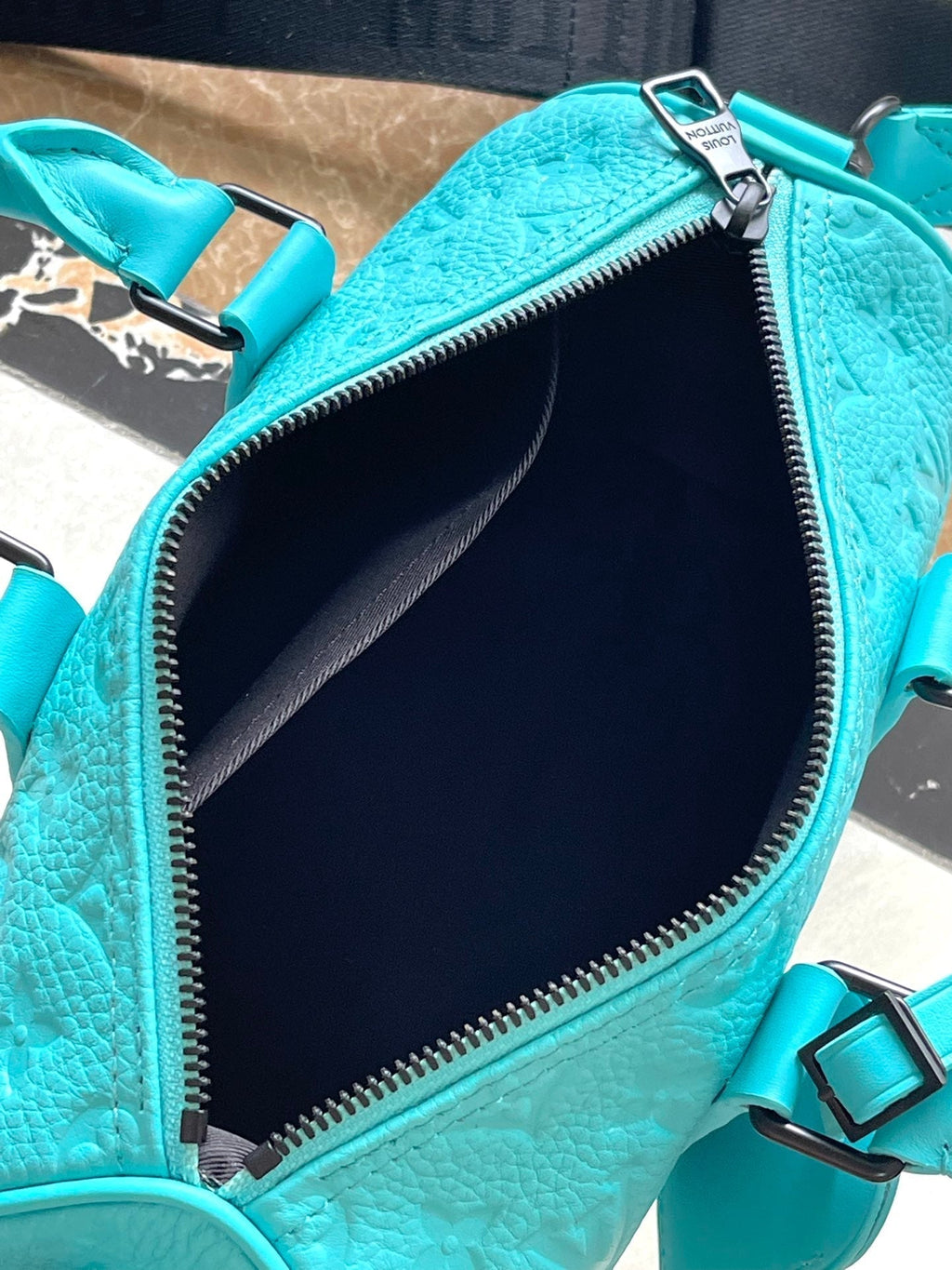 LOUIS VUITTON KEEPALL BANDOULIÈRE 25 IN TURQUOISE BLUE MONOGRAM EMBOSSED CALFSKIN