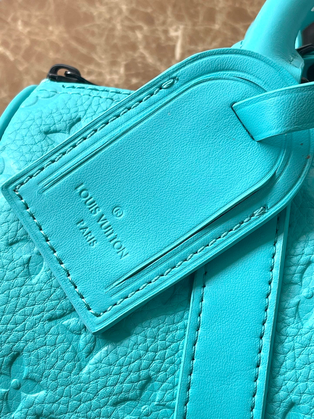 LOUIS VUITTON KEEPALL BANDOULIÈRE 25 IN TURQUOISE BLUE MONOGRAM EMBOSSED CALFSKIN