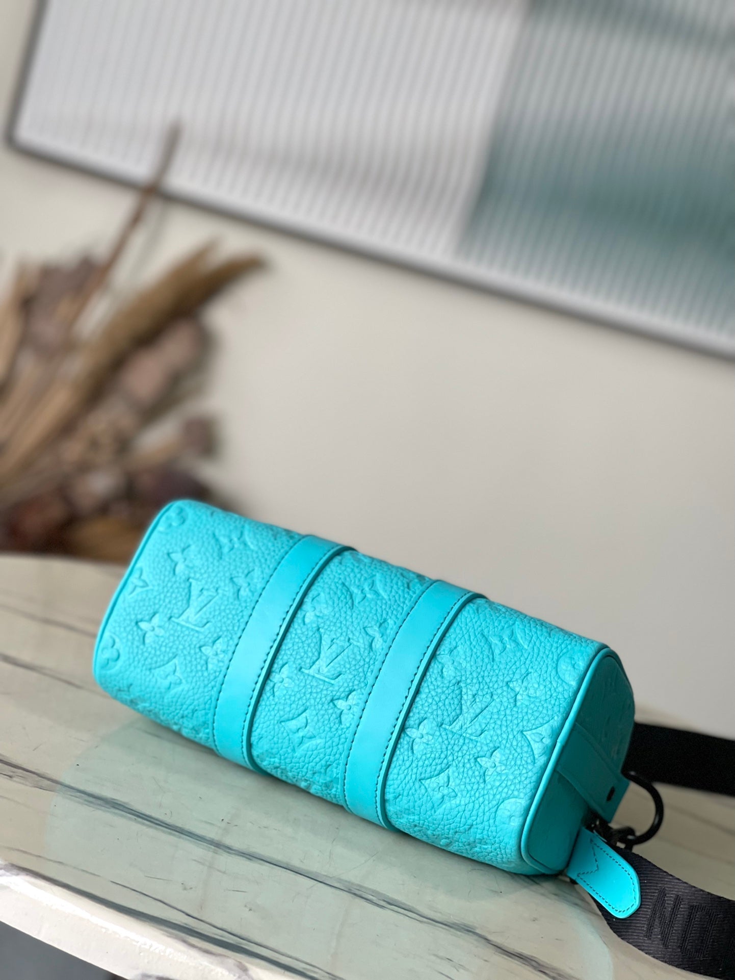LOUIS VUITTON KEEPALL BANDOULIÈRE 25 IN TURQUOISE BLUE MONOGRAM EMBOSSED CALFSKIN