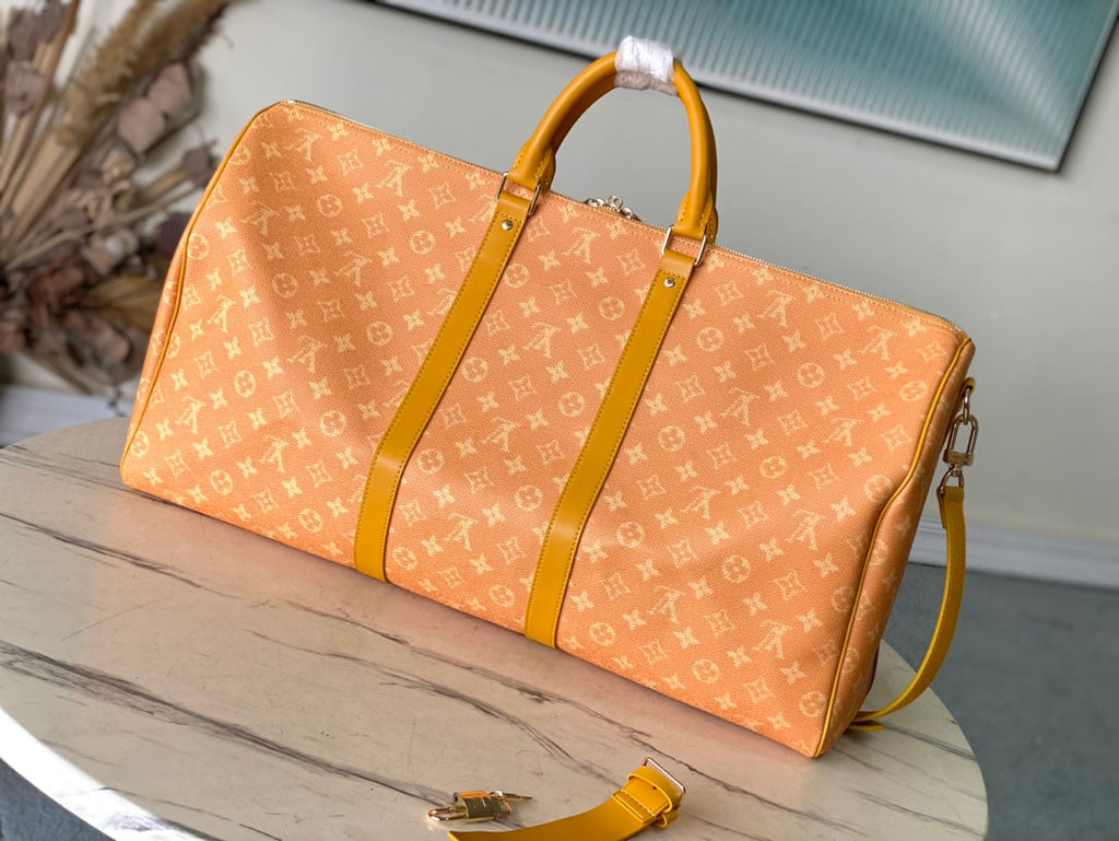 LOUIS VUITTON KEEPALL BANDOULIÈRE 55 IN ORANGE MONOGRAM HERITAGE CANVAS