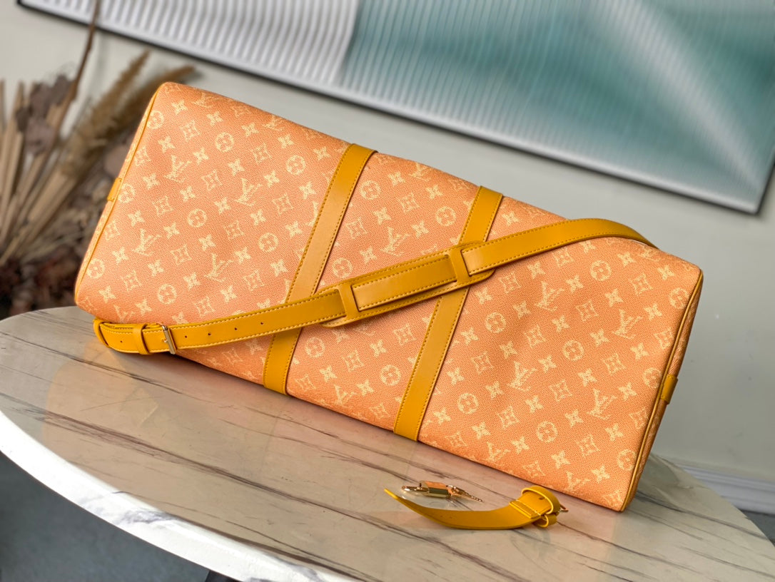 LOUIS VUITTON KEEPALL BANDOULIÈRE 55 IN ORANGE MONOGRAM HERITAGE CANVAS