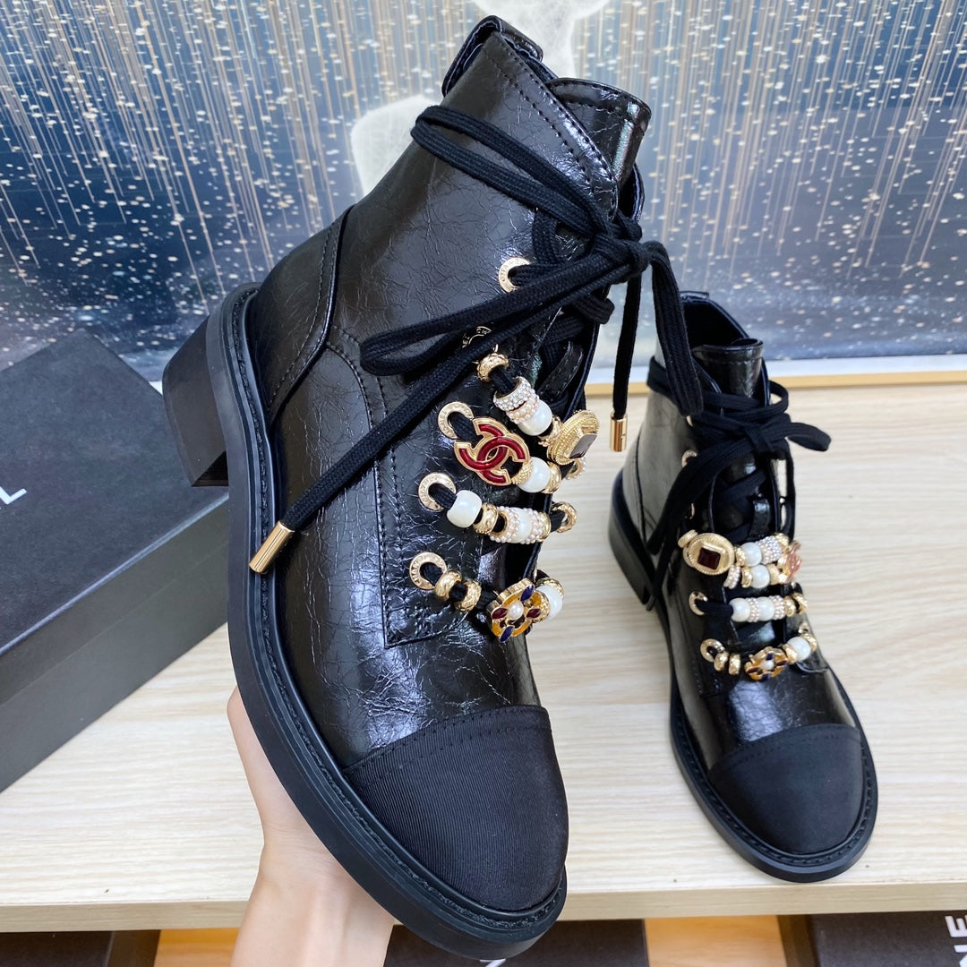 CHANEL COMBAT BOOTS IN BLACK WRINKLED CALFSKIN AND GROSGRAIN WITH FAUX PEARL