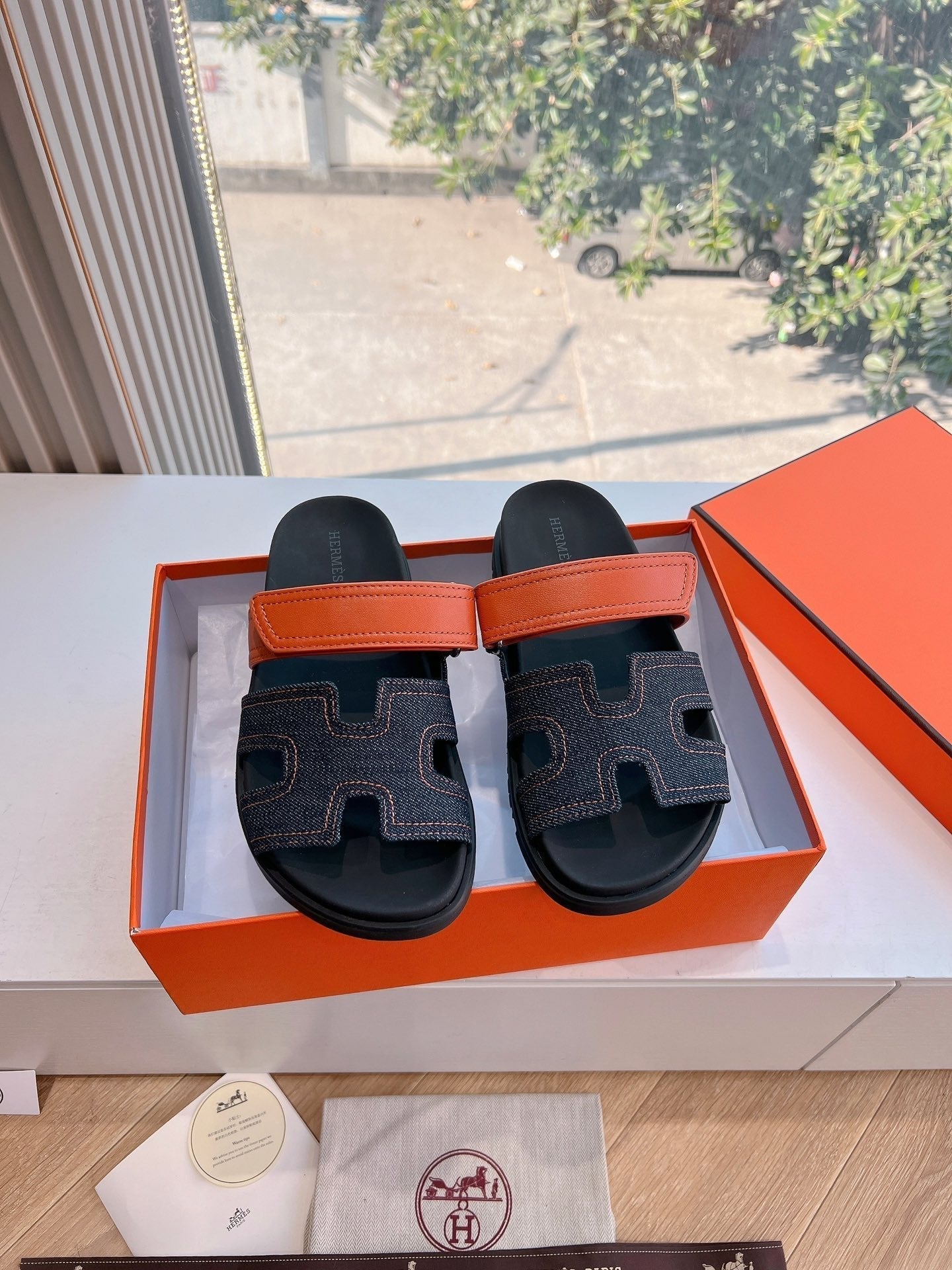 HERMES CHYPRE SANDAL IN BLACK DENIM AND VIVID ORANGE CALFSKIN