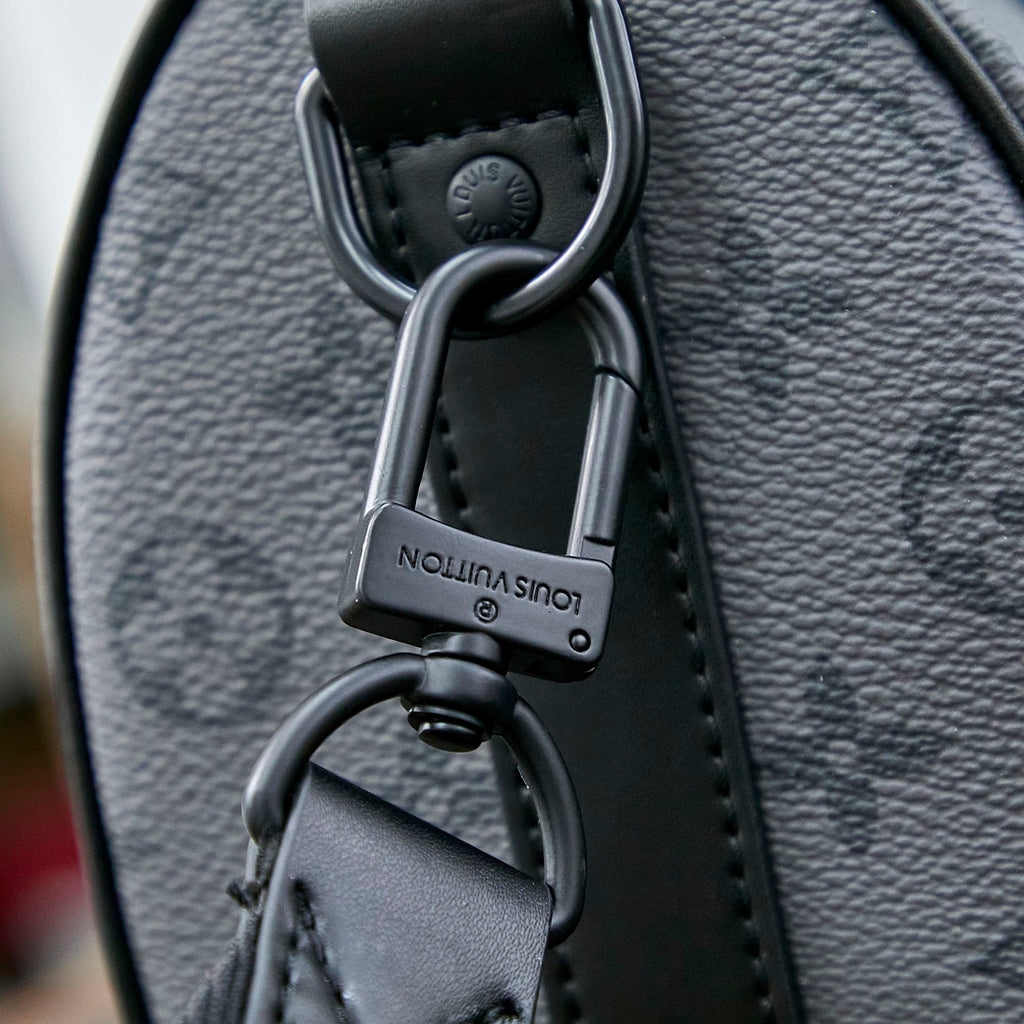 LOUIS VUITTON KEEPALL BANDOULIÈRE 25 IN GUN METAL MONOGRAM ECLIPSE CANVAS MIX TURQUOISE CALFSKIN