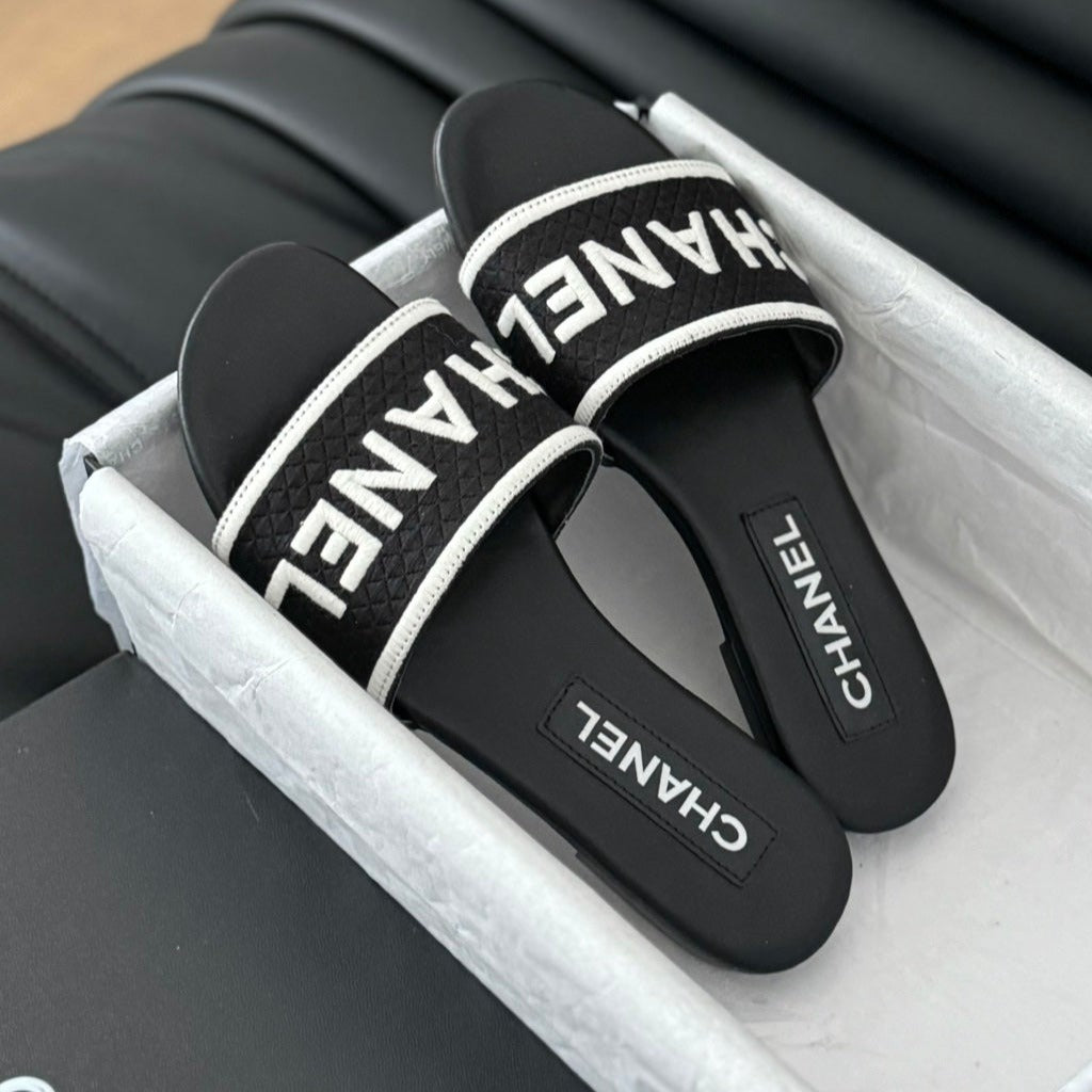 CHANEL Woven Embroidered Letter Slippers Black White