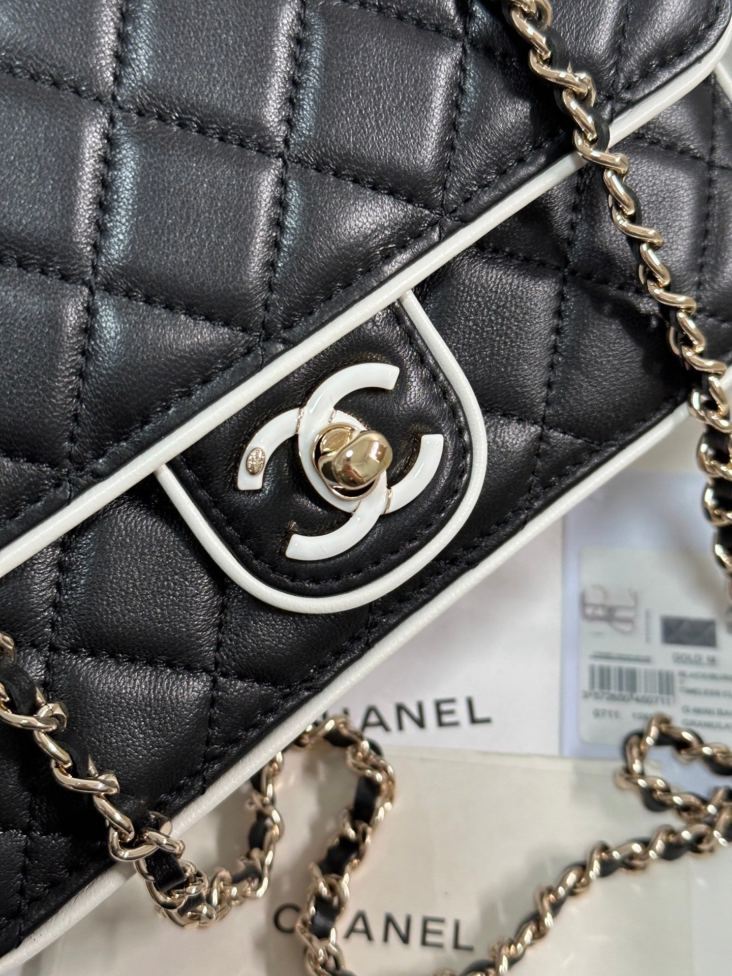 CHANEL QUILTED FLAP BAG WITH WHITE TRIM 19 IN BLACK LAMBSKIN