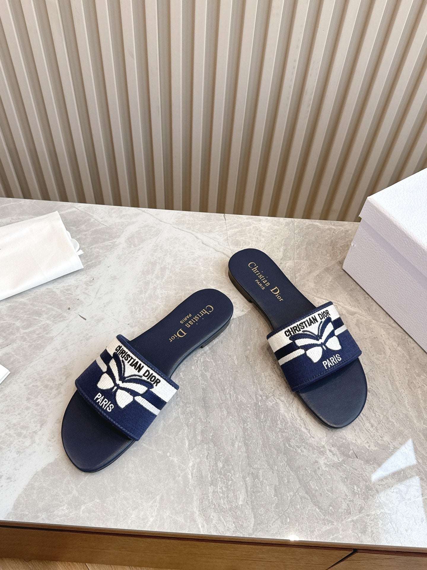 DIOR FLAT SLIDES 25S IN MIDNIGHT BLUE CALFSKIN AND FABRIC EMBROIDERED BUTTERFLY MOTIF