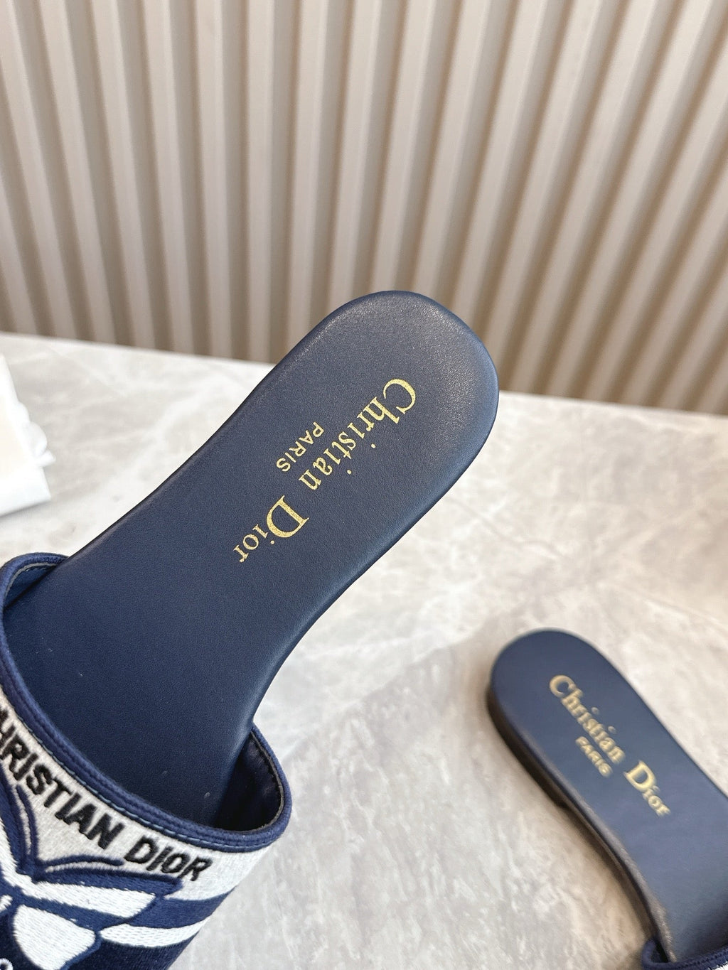 DIOR FLAT SLIDES 25S IN MIDNIGHT BLUE CALFSKIN AND FABRIC EMBROIDERED BUTTERFLY MOTIF